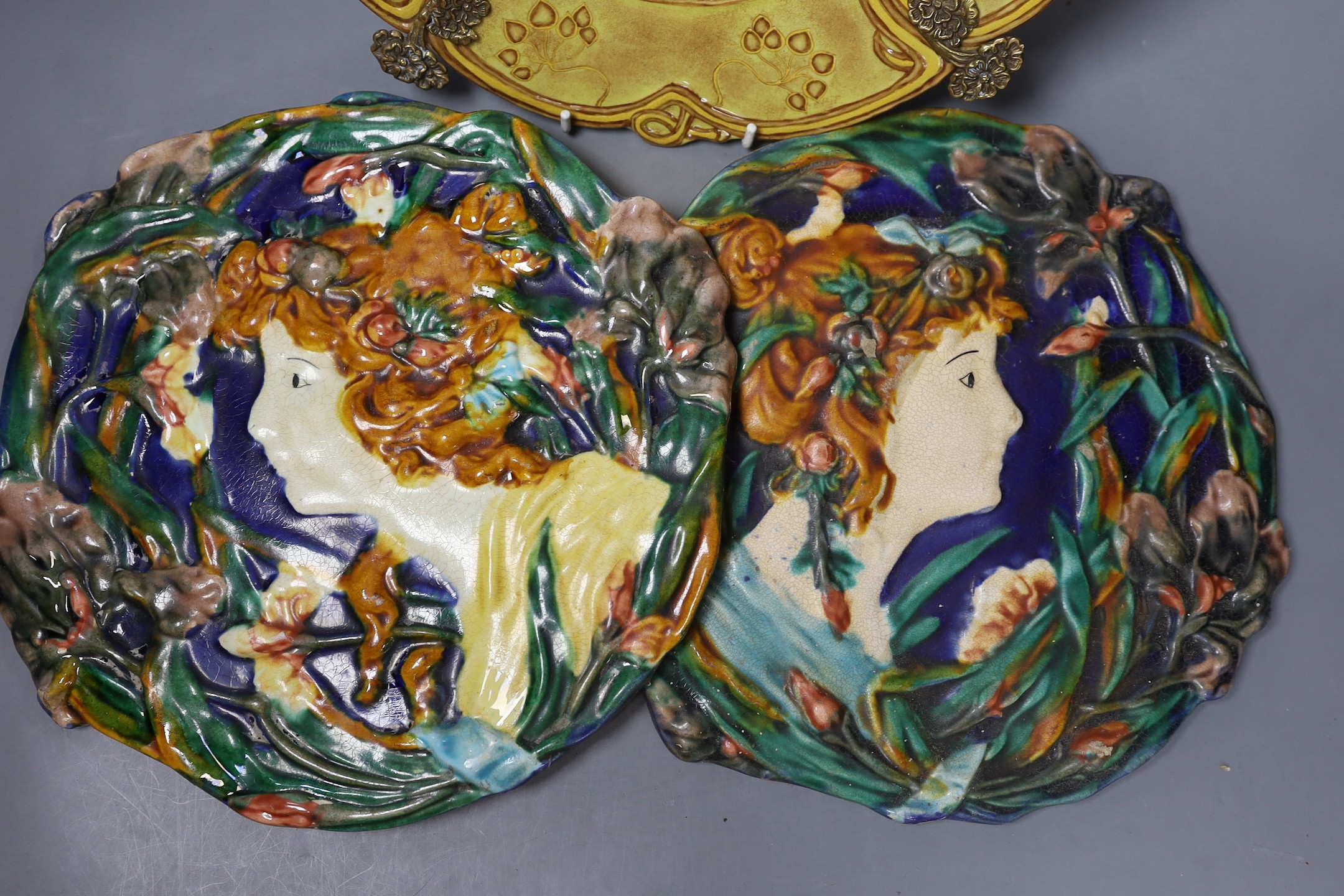 Two Continental Art Nouveau style plaques and a brass mounted dish, dish 31.5 cms diameter.